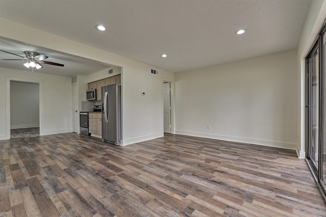 unfurnished living room featuring ceiling fan, hardwood / wood-style floors, and a textured ceiling