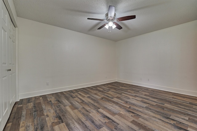 unfurnished room featuring dark hardwood / wood-style floors, ceiling fan, and a textured ceiling