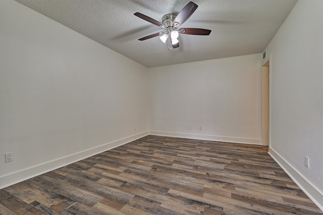 empty room featuring ceiling fan, dark hardwood / wood-style flooring, and a textured ceiling