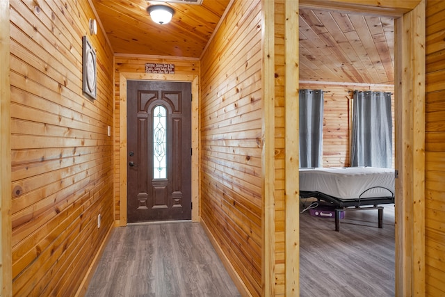 entryway featuring wooden ceiling, wood-type flooring, and wood walls