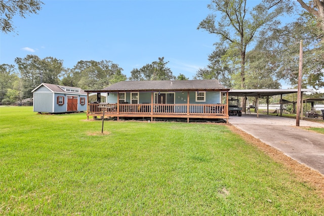 view of front of house with a carport, a shed, and a front yard