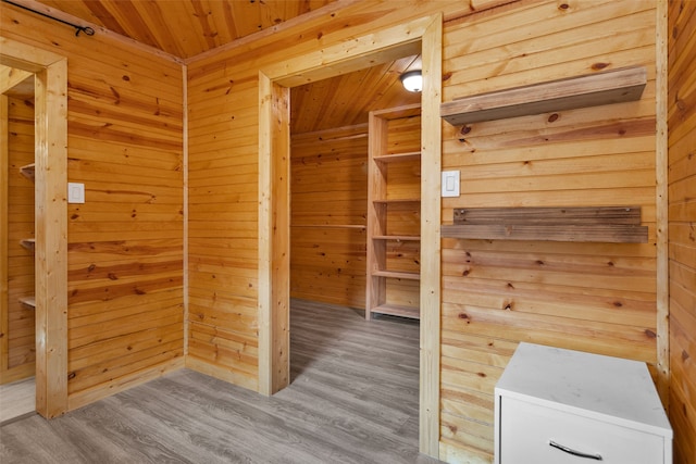 interior space featuring hardwood / wood-style flooring, wooden walls, and wood ceiling