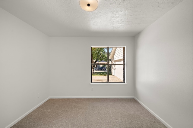 spare room with carpet floors and a textured ceiling