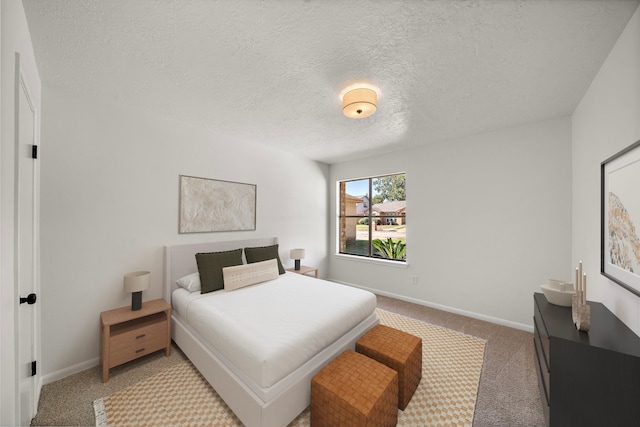 bedroom featuring a textured ceiling and light carpet