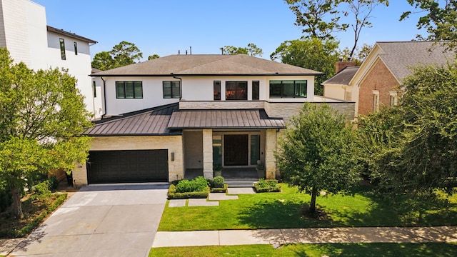 view of front of home featuring a garage and a front yard