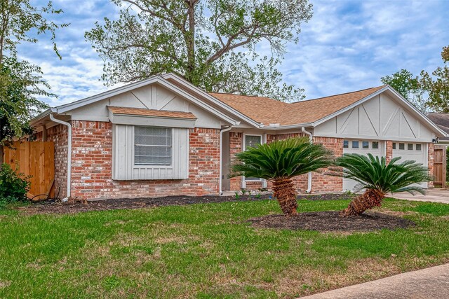 view of front of property with a garage and a front lawn