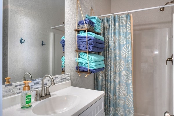 bathroom featuring vanity and shower / tub combo with curtain