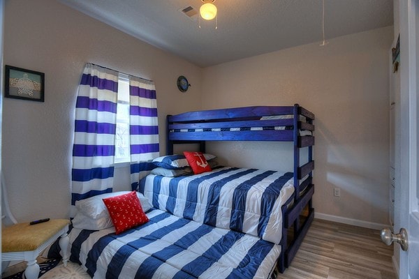 bedroom with ceiling fan and light hardwood / wood-style floors