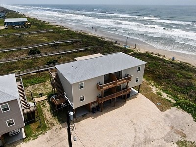 drone / aerial view featuring a view of the beach and a water view