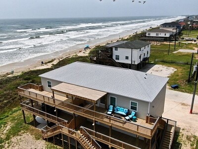 drone / aerial view featuring a water view and a beach view