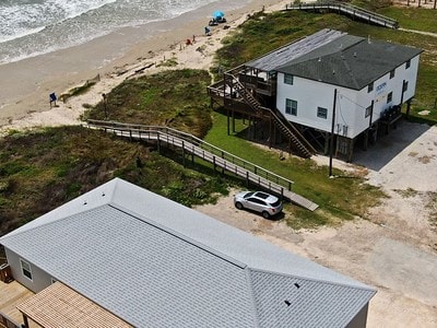 drone / aerial view featuring a view of the beach and a water view