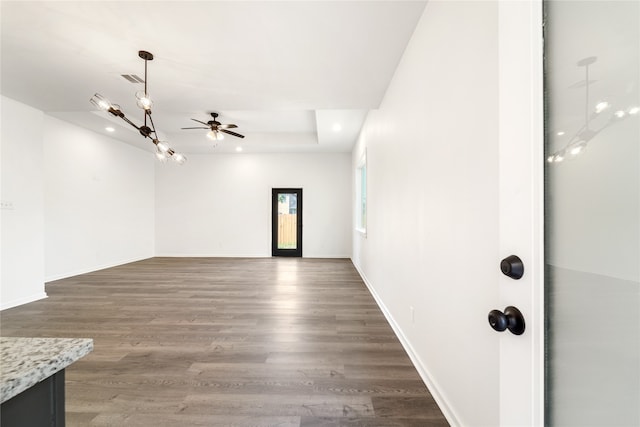 unfurnished room with ceiling fan and dark wood-type flooring