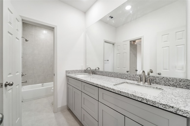 bathroom featuring vanity and tiled shower / bath combo