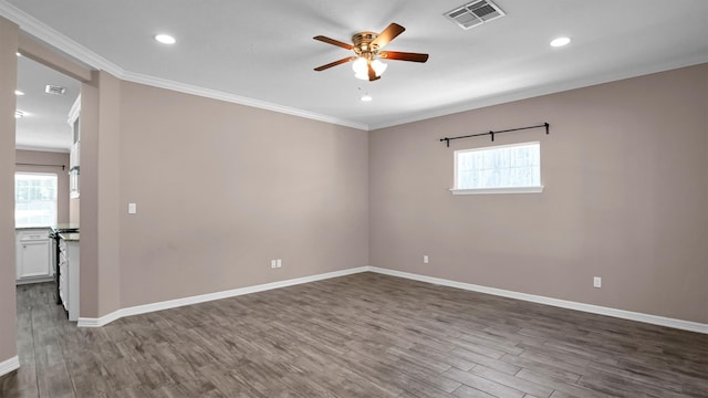 unfurnished room with a wealth of natural light, dark hardwood / wood-style flooring, and crown molding