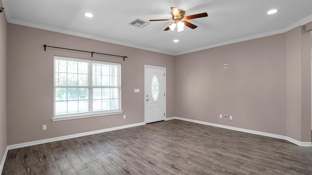 foyer entrance with ornamental molding, ceiling fan, and dark wood-type flooring