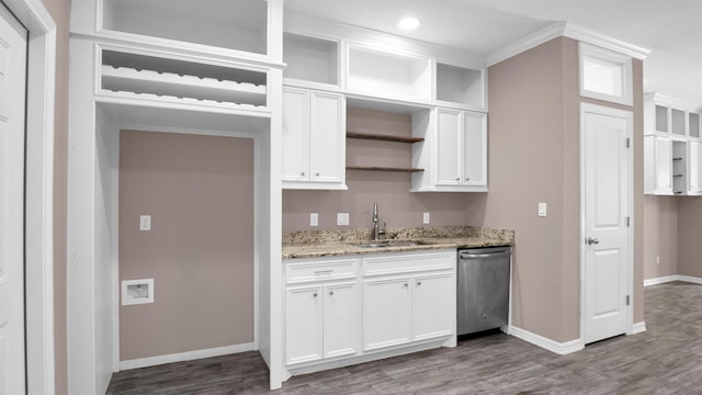 kitchen with white cabinetry, sink, light stone counters, stainless steel dishwasher, and ornamental molding