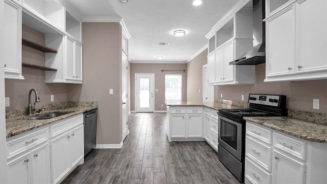 kitchen with appliances with stainless steel finishes, ornamental molding, sink, wall chimney range hood, and white cabinets