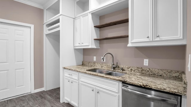 kitchen featuring light stone counters, ornamental molding, sink, dishwasher, and white cabinetry