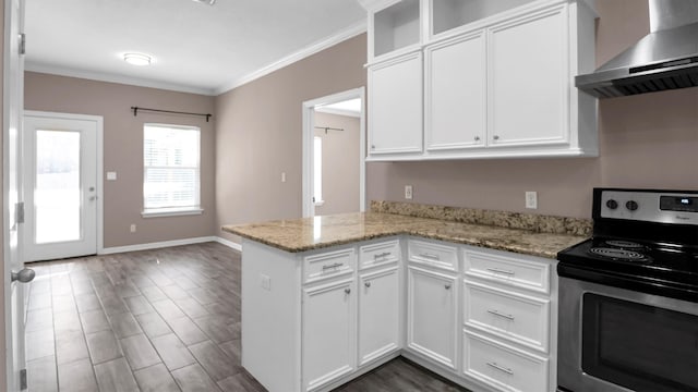 kitchen featuring light stone countertops, white cabinetry, wall chimney exhaust hood, and electric range