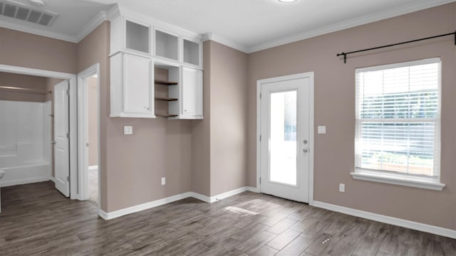 interior space with ornamental molding and dark wood-type flooring