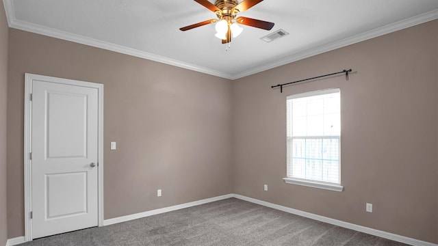 carpeted spare room with ceiling fan and crown molding