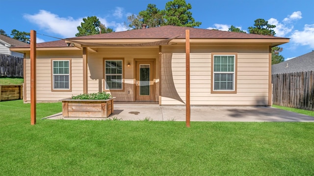 back of house featuring a patio and a lawn