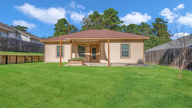 back of house with a lawn and a patio area