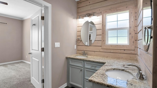 bathroom featuring vanity, wood walls, and crown molding