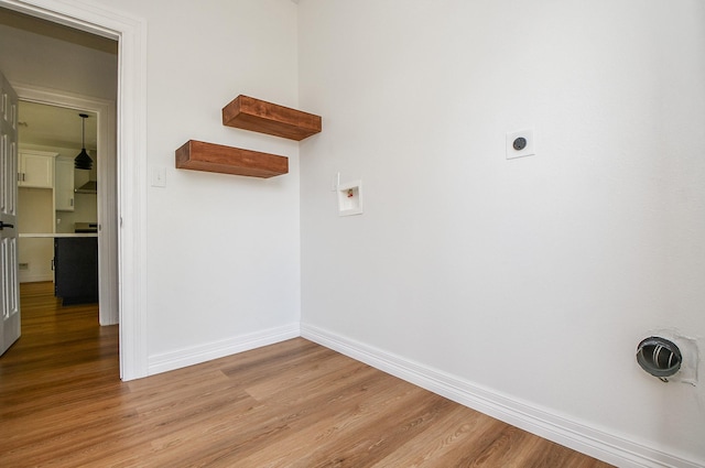 clothes washing area featuring electric dryer hookup, washer hookup, and light hardwood / wood-style floors