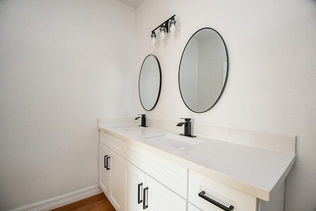 bathroom with hardwood / wood-style floors and vanity