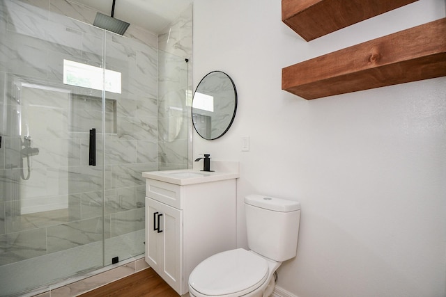 bathroom with vanity, wood-type flooring, a shower with shower door, and toilet