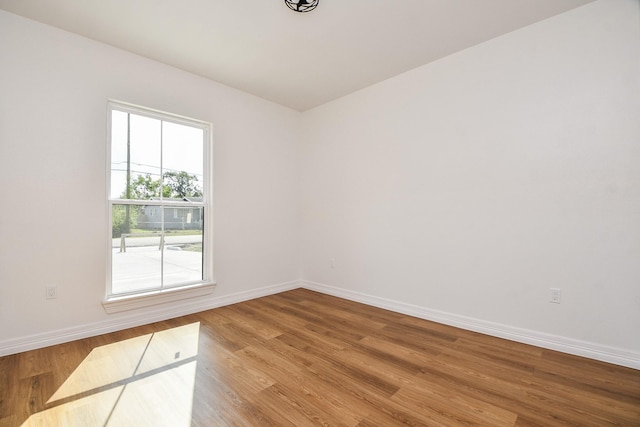 empty room with hardwood / wood-style flooring