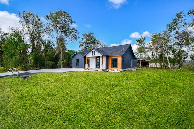 modern farmhouse with a front lawn