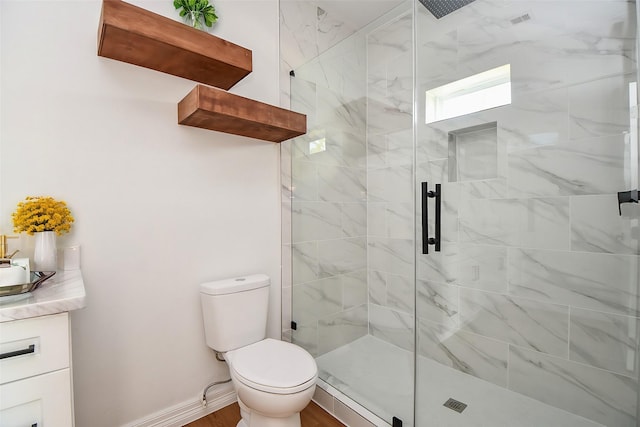 bathroom featuring hardwood / wood-style floors, vanity, toilet, and walk in shower