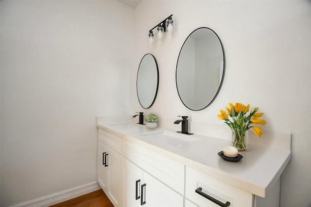 bathroom with vanity and hardwood / wood-style floors