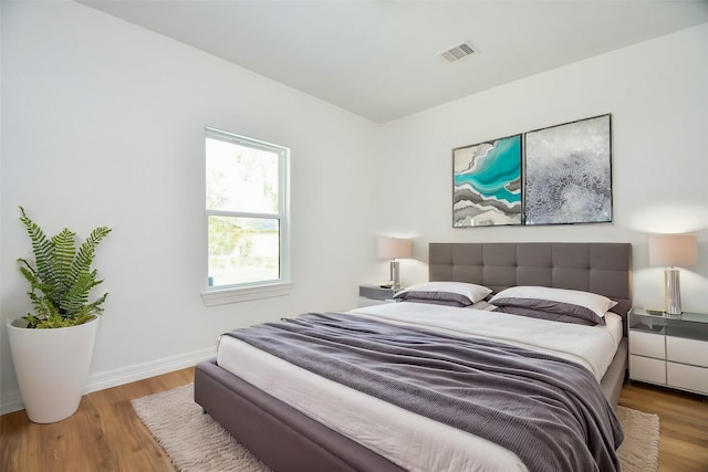 bedroom with wood-type flooring