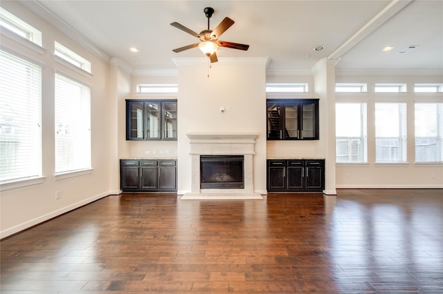 unfurnished living room with ceiling fan, dark hardwood / wood-style floors, and ornamental molding