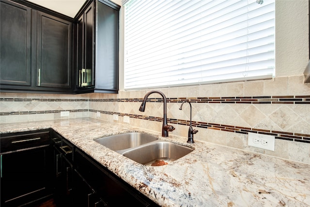 kitchen with light stone counters and sink