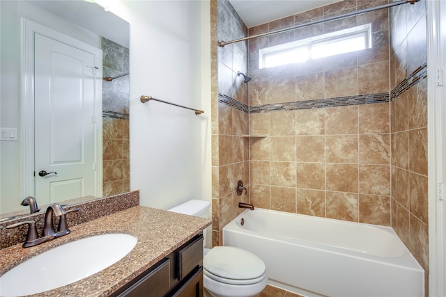 full bathroom featuring tiled shower / bath combo, toilet, and vanity