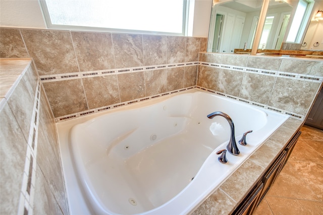 bathroom featuring tile patterned floors, a wealth of natural light, and tiled bath