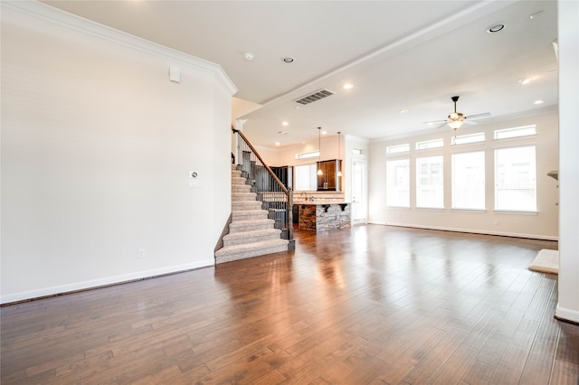 unfurnished living room featuring dark hardwood / wood-style flooring, ceiling fan, and ornamental molding