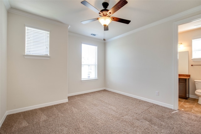 carpeted empty room with ceiling fan and ornamental molding