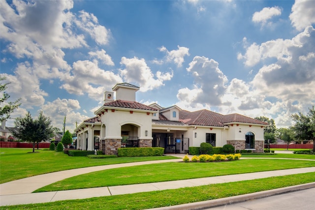 mediterranean / spanish-style house featuring a front lawn