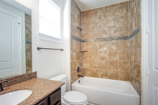 full bathroom with toilet, vanity, and tiled shower / bath