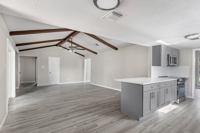 kitchen with gray cabinets, light wood-type flooring, backsplash, and appliances with stainless steel finishes