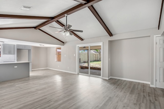 unfurnished living room with vaulted ceiling with beams, ceiling fan, and wood-type flooring