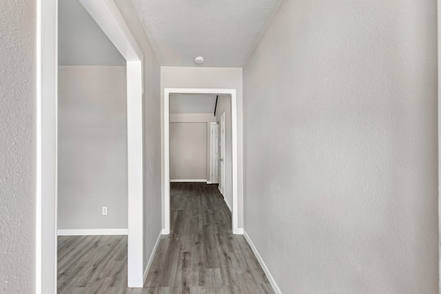 corridor with light hardwood / wood-style floors