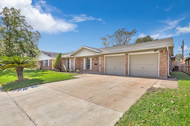 single story home featuring central AC unit, a garage, and a front yard