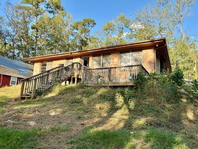 back of house with a wooden deck