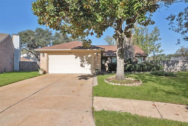 view of front of property with a garage and a front lawn